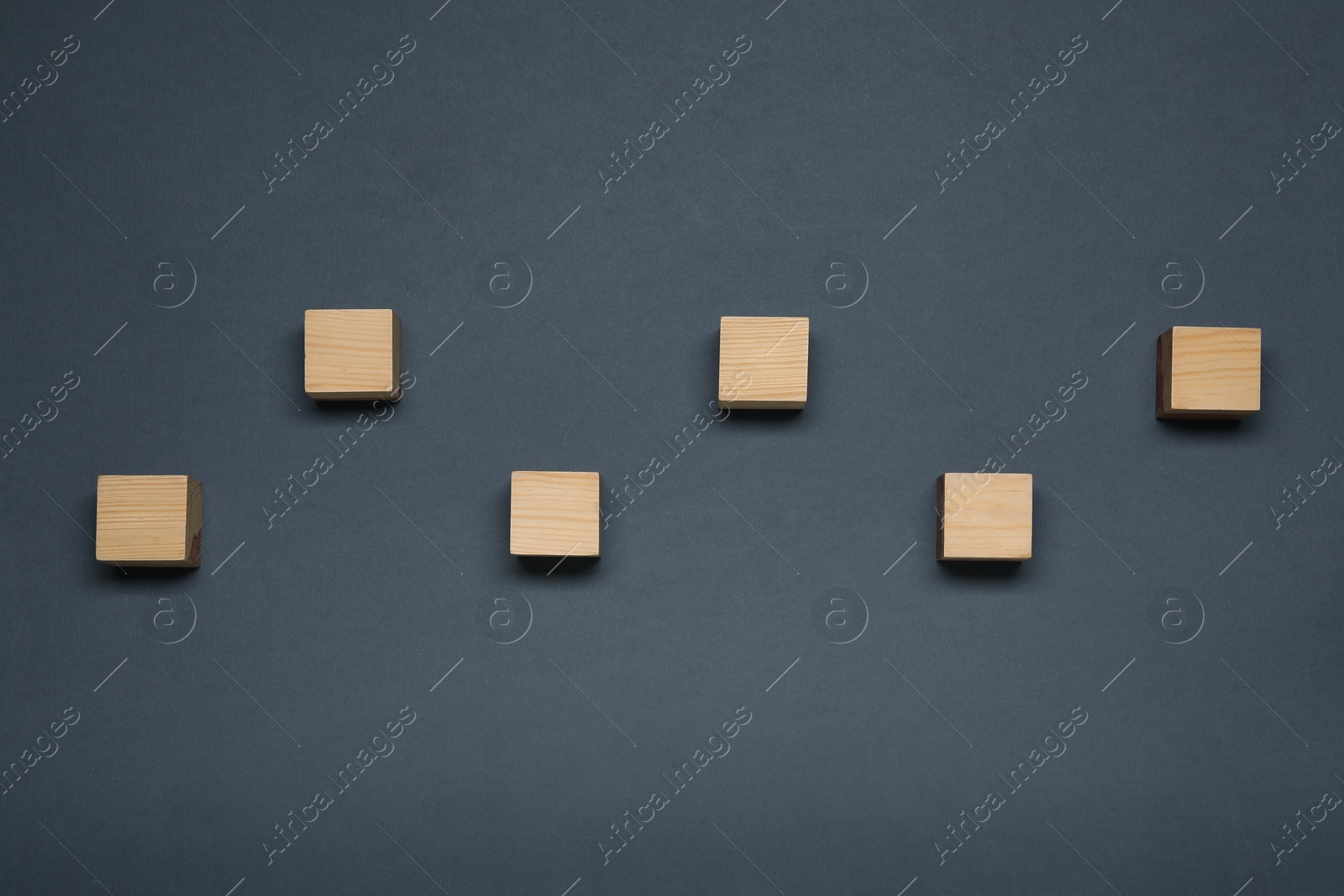 Photo of Blank wooden cubes on dark grey background, flat lay