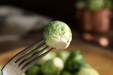 Fresh Brussels sprout on fork, closeup view