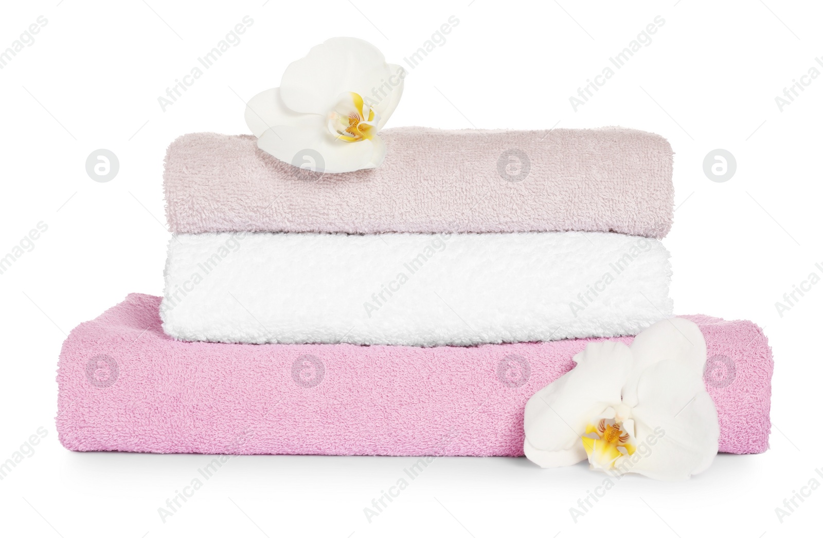 Photo of Stack of clean soft towels with orchids isolated on white