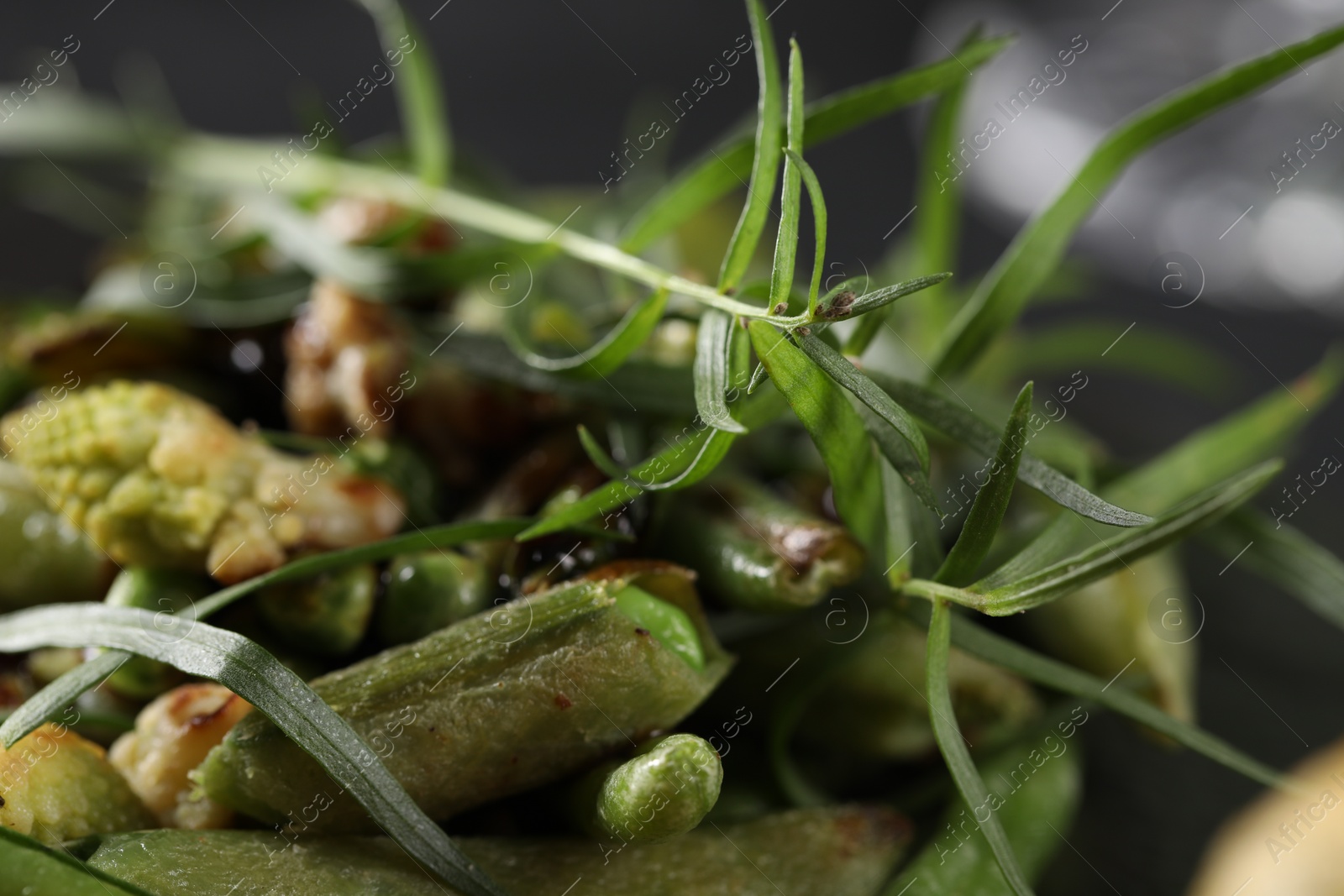 Photo of Delicious tarragon and baked vegetables on table, closeup