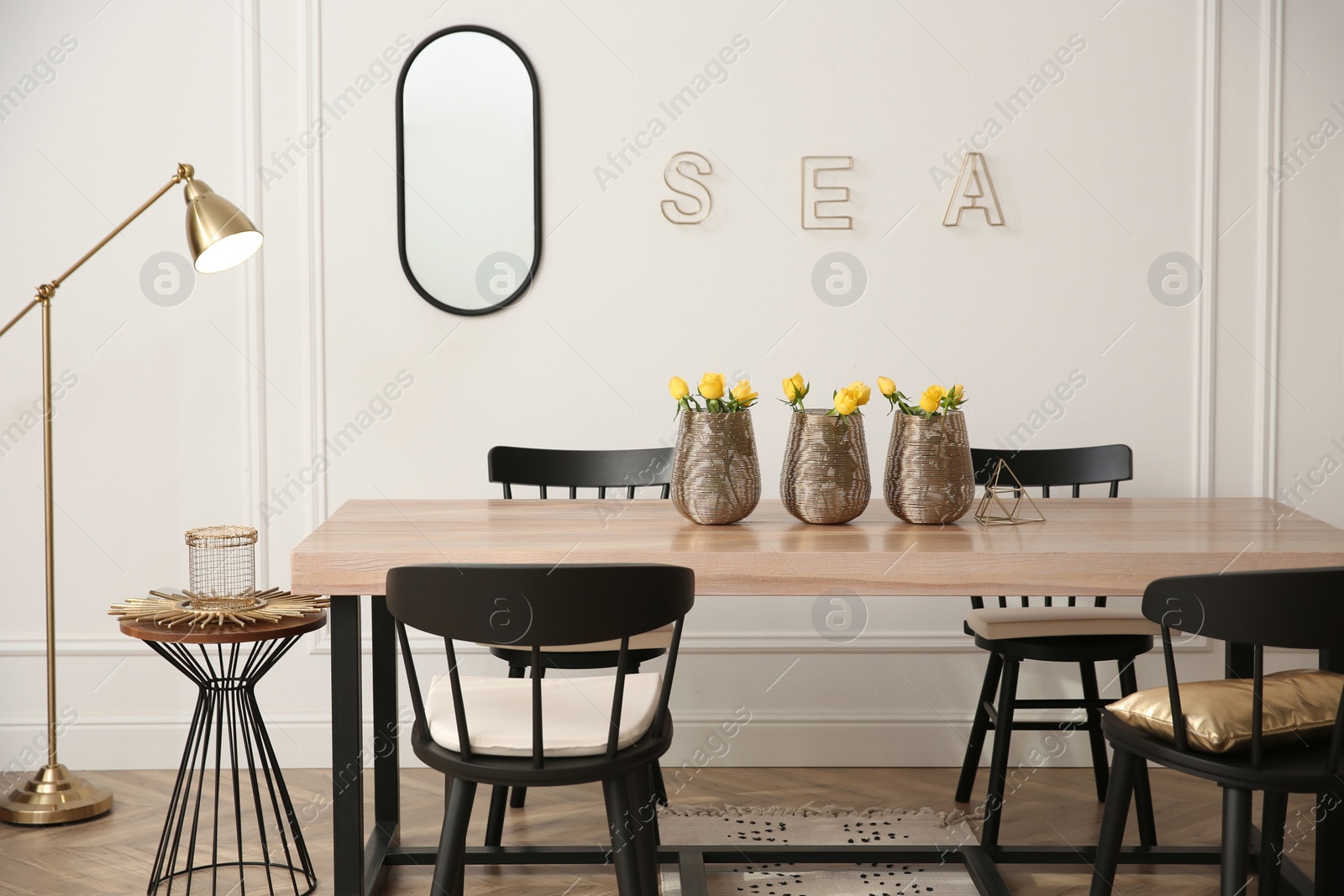 Photo of Stylish wooden dining table and chairs in room. Interior design