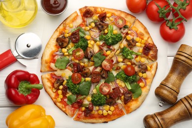 Photo of Delicious vegetarian pizza served on white wooden table, flat lay