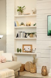 Photo of Shelves with different decor in room. Interior design