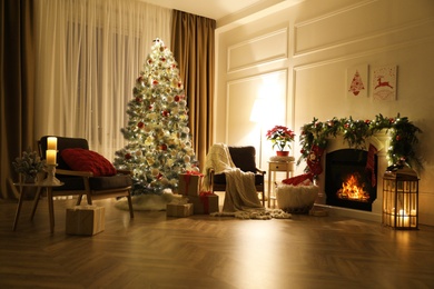 Photo of Stylish room interior with fireplace and beautiful Christmas tree