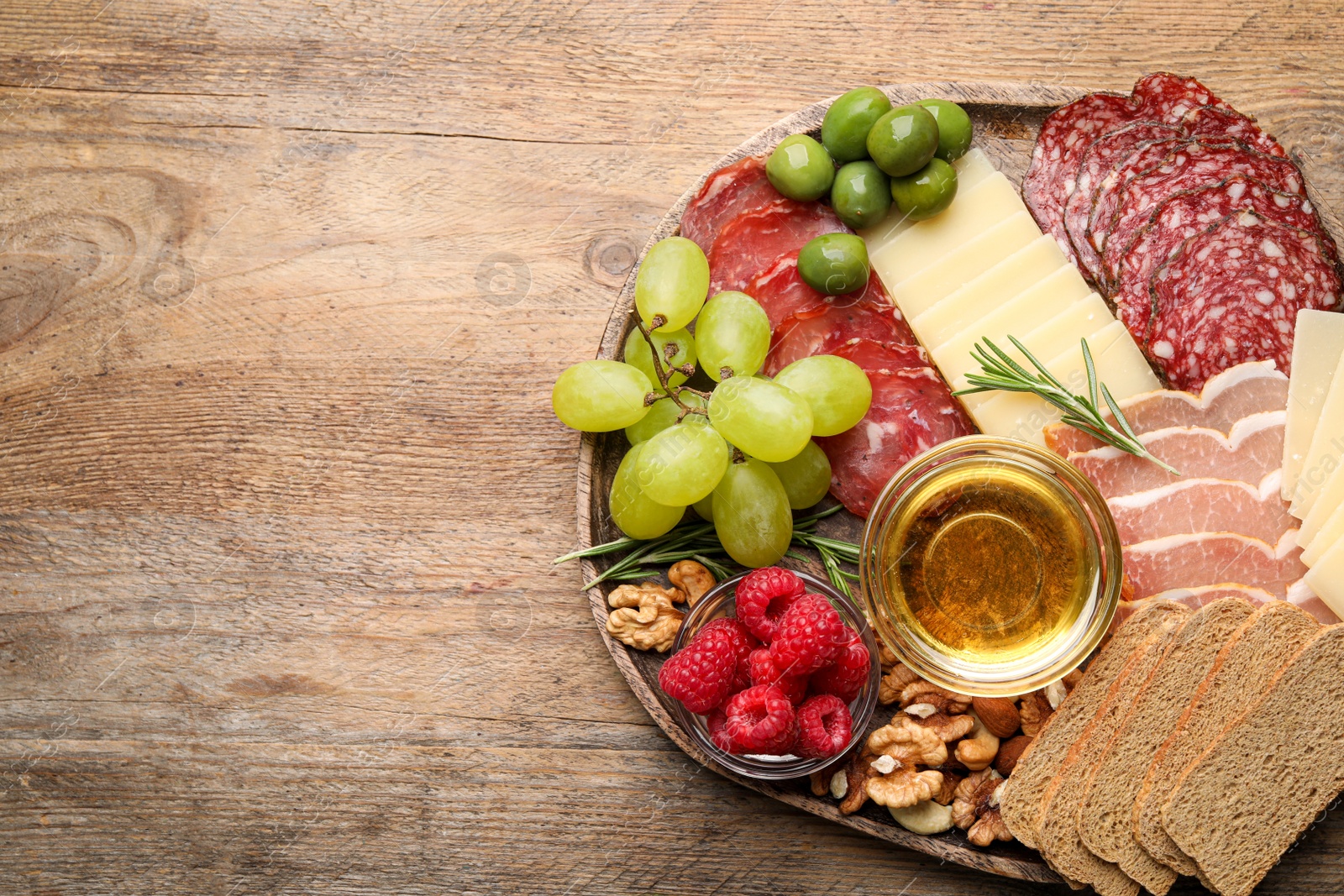 Photo of Snack set with delicious Parmesan cheese on wooden table, top view. Space for text