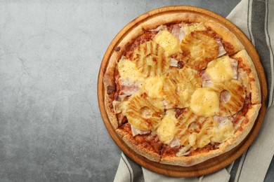 Delicious pineapple pizza on gray table, top view. Space for text
