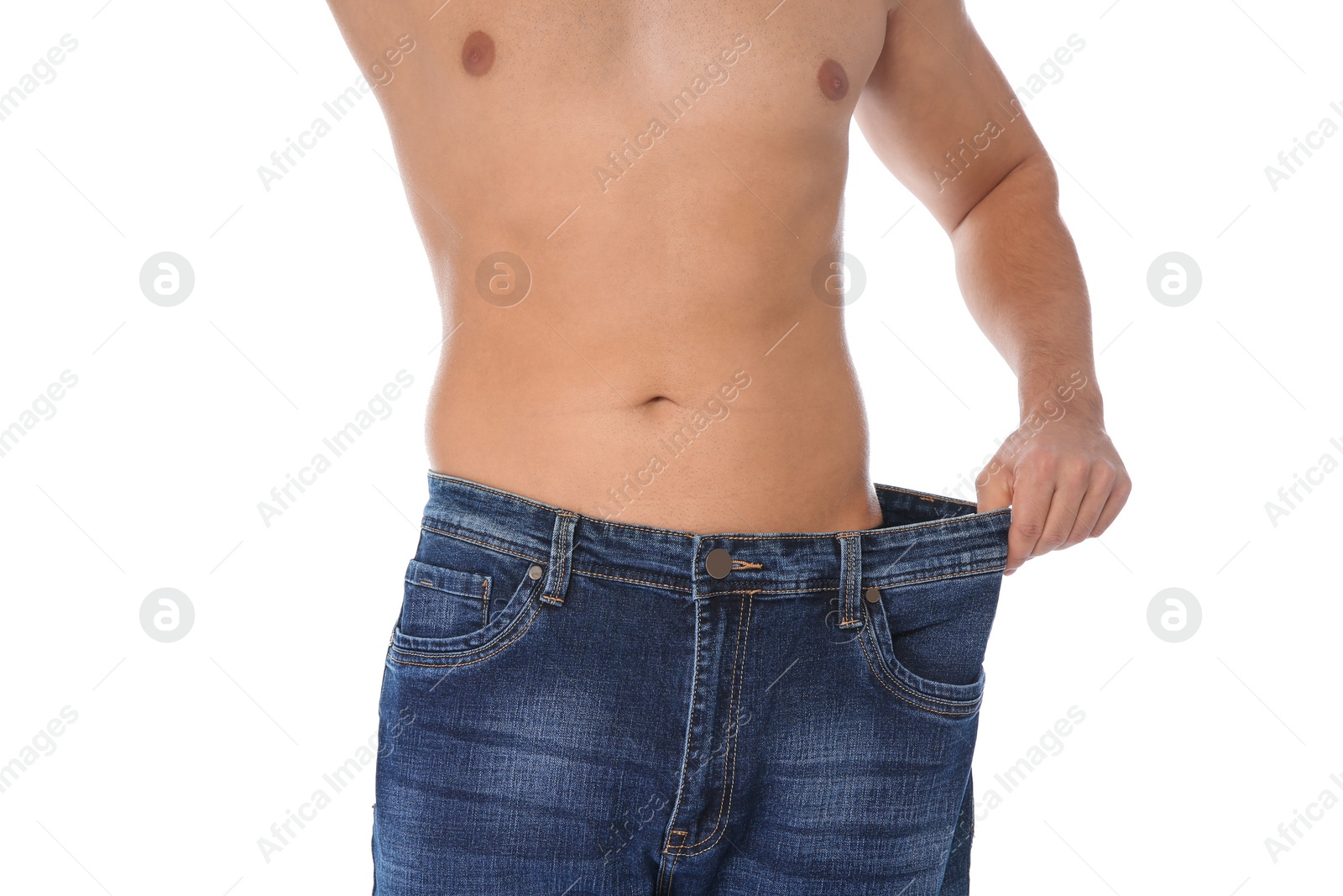 Photo of Fit man in oversized jeans on white background, closeup. Weight loss