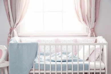 Baby room interior with comfortable crib