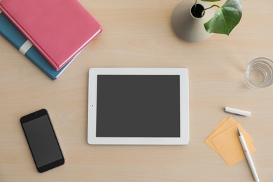 Photo of Flat lay composition with modern tablet on table. Space for design