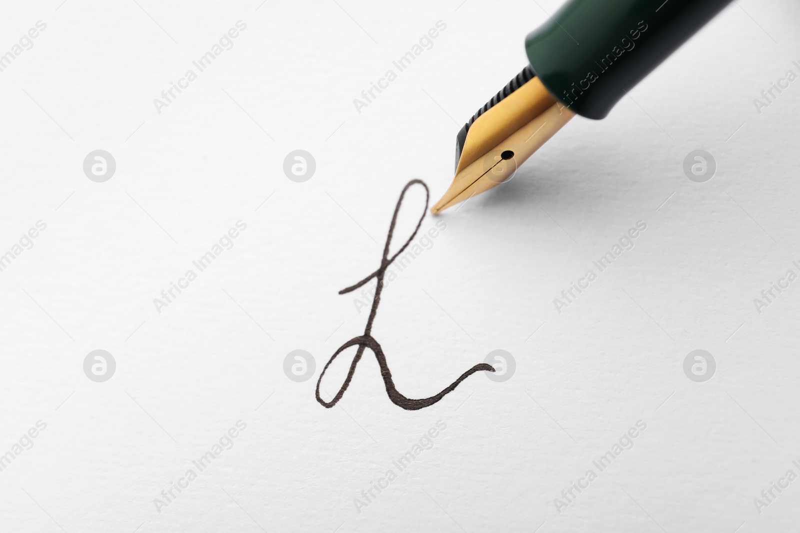 Photo of Signing on sheet of paper with fountain pen, closeup