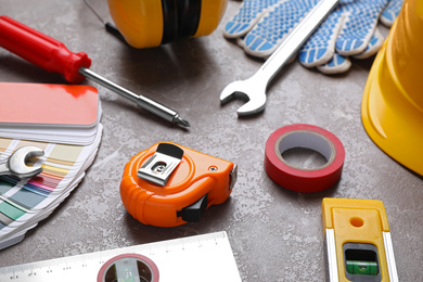 Photo of Many different construction tools on grey marble table