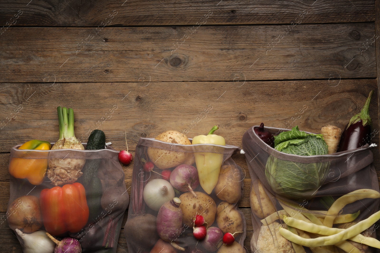 Photo of Different fresh ripe vegetables on wooden table, flat lay. Space for text