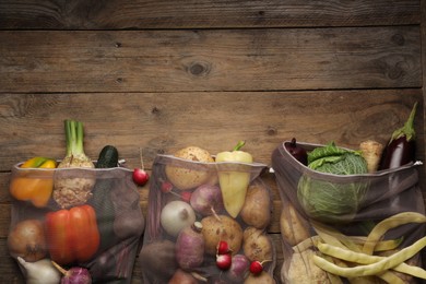 Different fresh ripe vegetables on wooden table, flat lay. Space for text