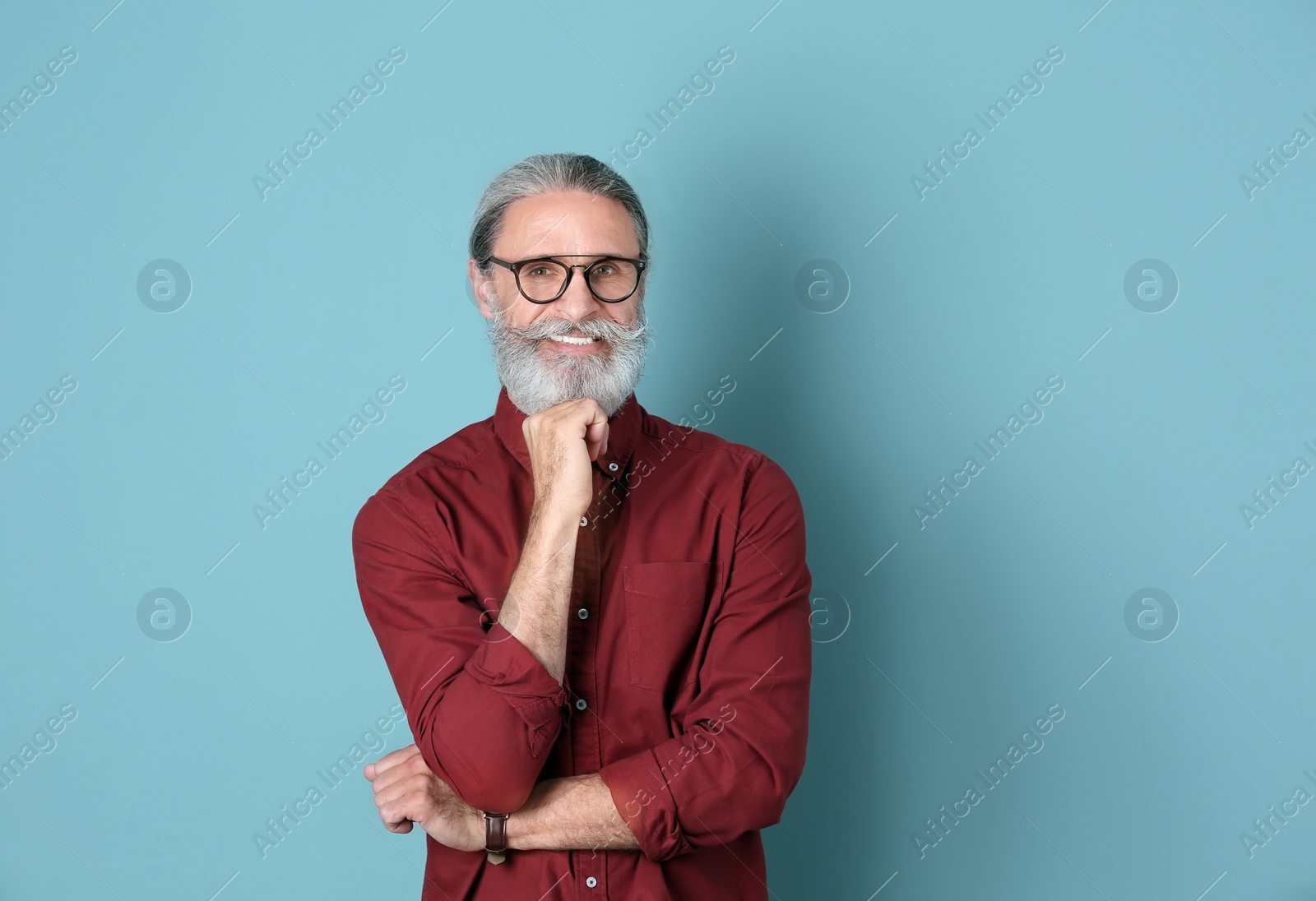 Photo of Portrait of handsome mature man on color background