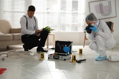Photo of Investigators working at crime scene in living room