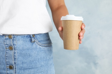 Photo of Woman with carton cup, closeup. Mock up for design