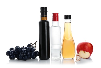 Composition with different kinds of vinegar and ingredients on white background