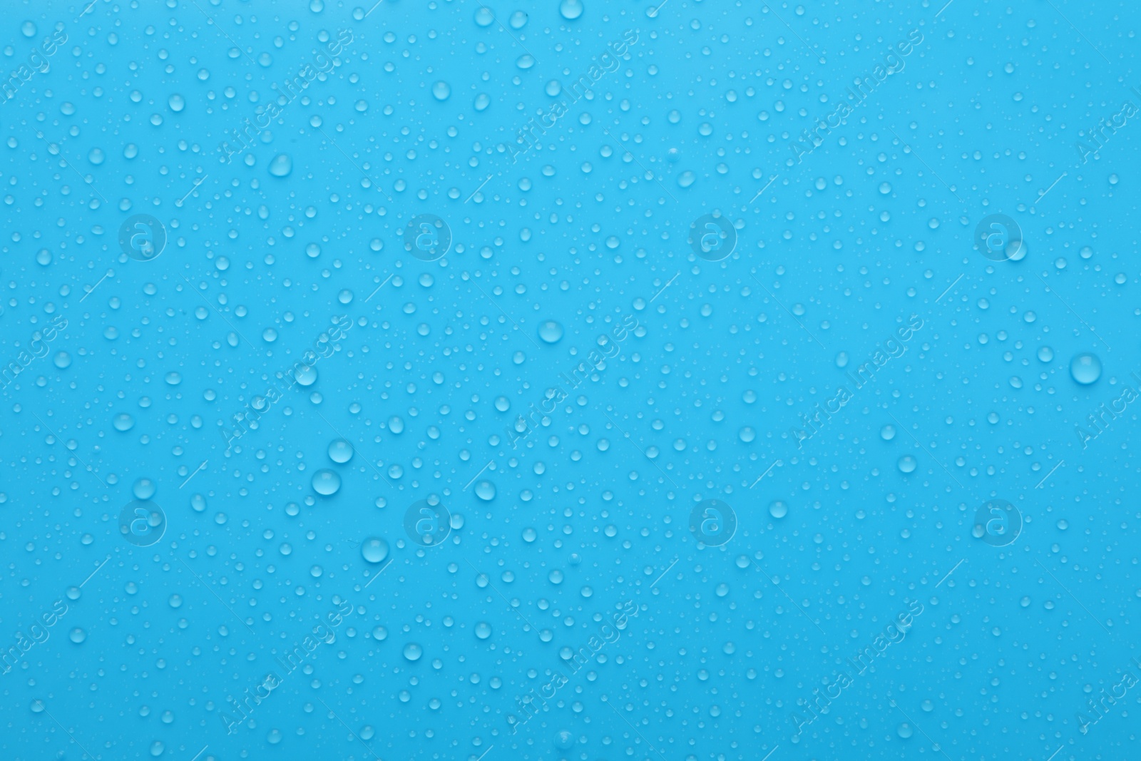 Photo of Water drops on light blue background, top view