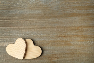 Photo of Decorative hearts and space for text on wooden table, flat lay. Valentine's Day