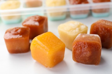 Photo of Frozen fruit puree cubes on table, closeup