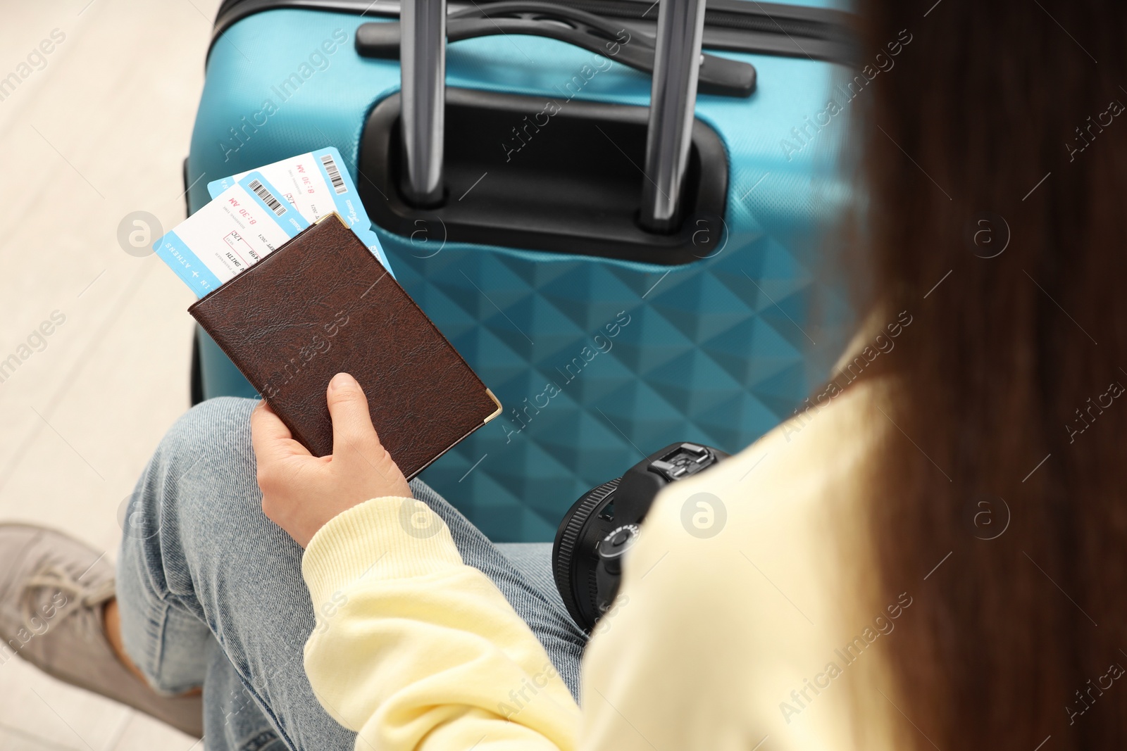 Photo of Woman with suitcase, camera, passport and tickets, closeup