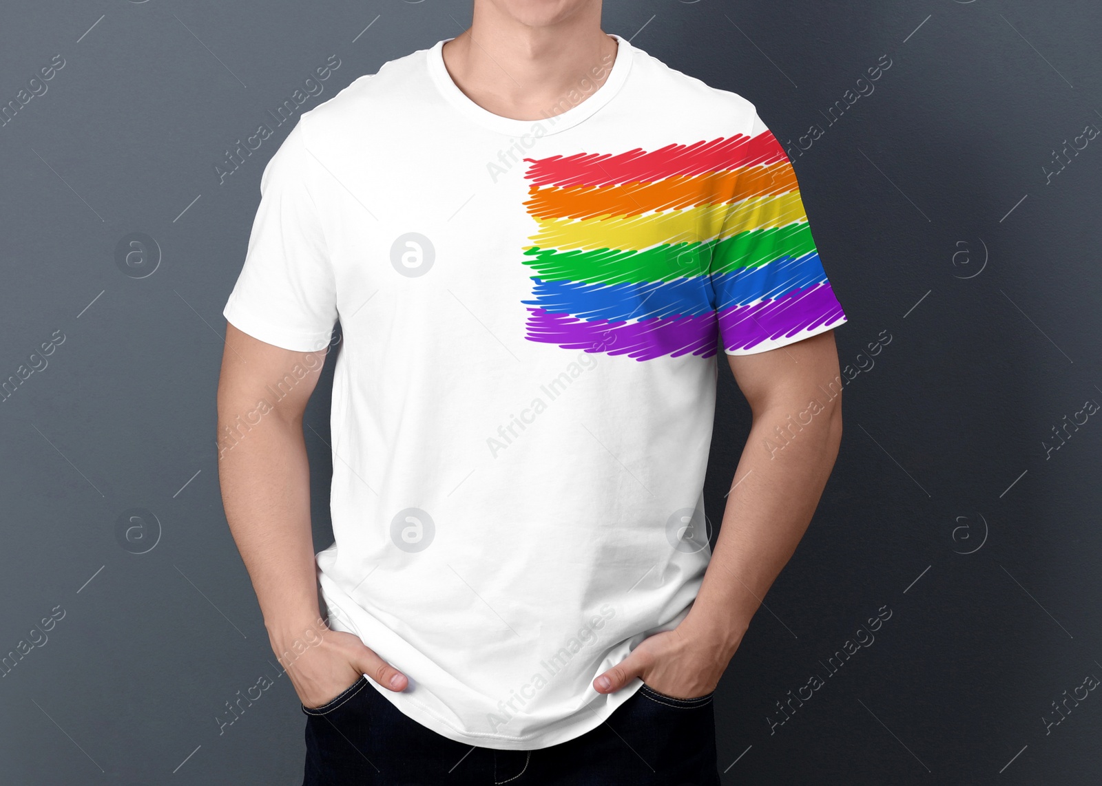 Image of Young man wearing white t-shirt with image of LGBT pride flag on grey background