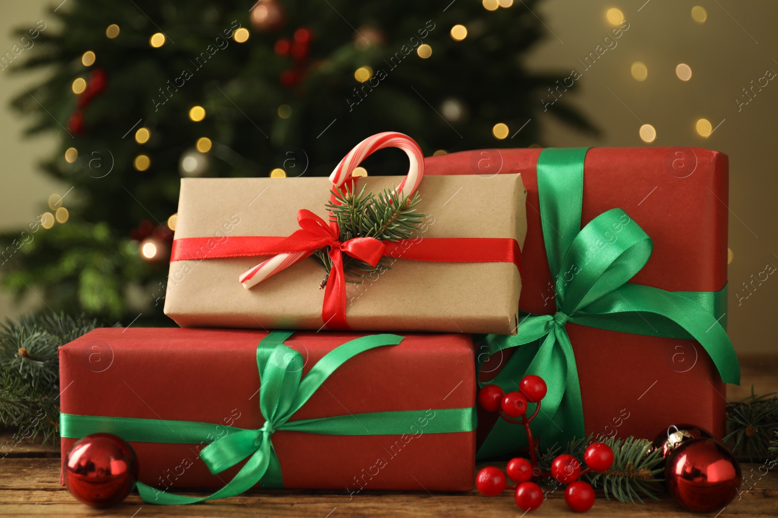 Photo of Beautiful gift boxes and Christmas decor on wooden table, closeup