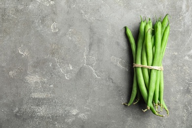 Fresh green beans on grey table, top view. Space for text