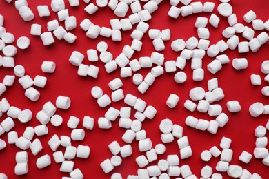 Photo of Delicious marshmallows on red background, flat lay