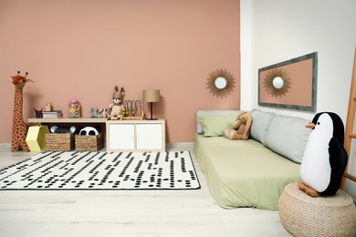 Photo of Montessori bedroom interior with floor bed and toys