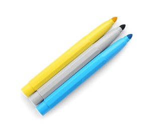 Different colorful markers on white background, top view