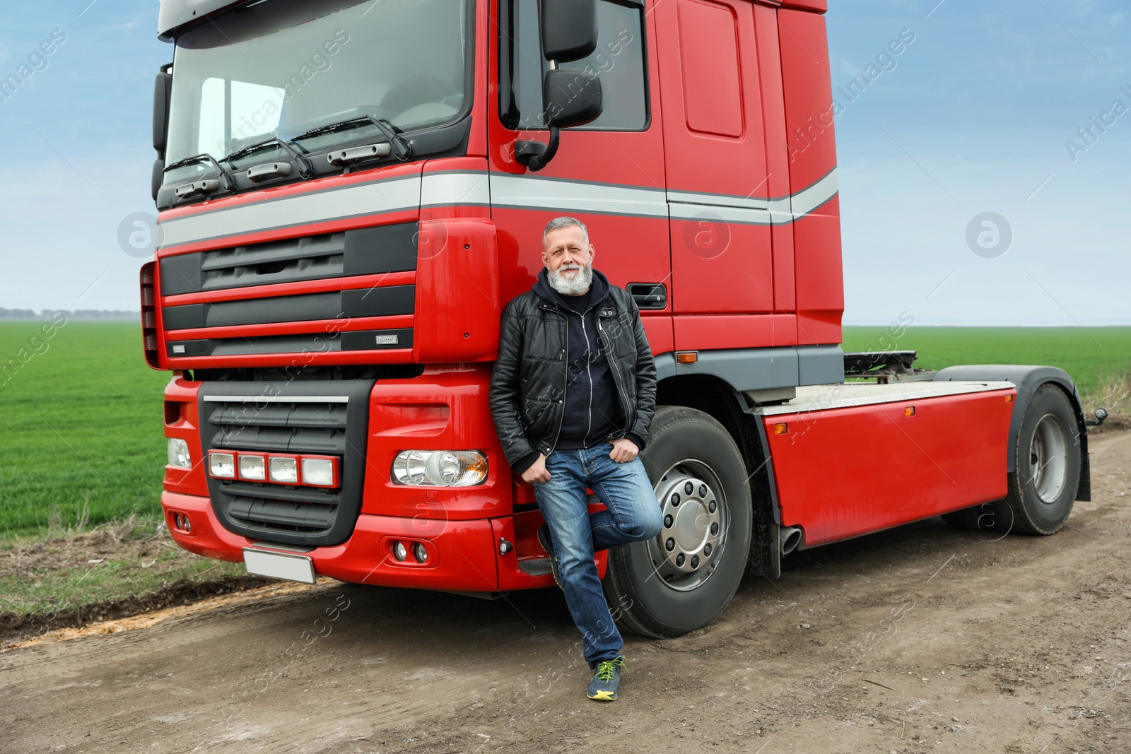 Photo of Portrait of mature driver at modern truck outdoors