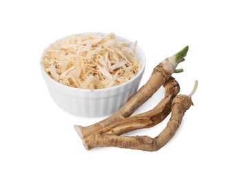 Photo of Grated and cut horseradish roots isolated on white