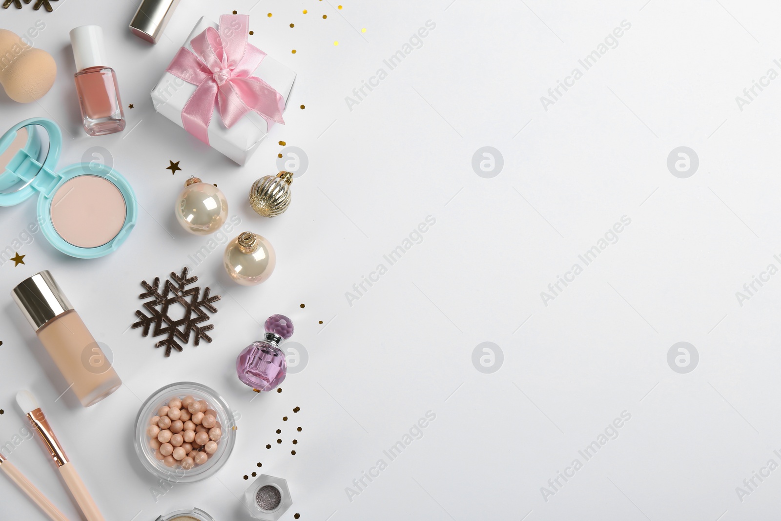 Photo of Flat lay composition with decorative cosmetic products on light background. Winter care. Space for text