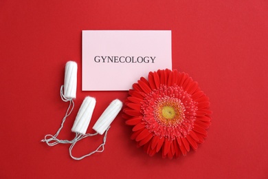 Flat lay composition with flower and tampons on color background. Gynecological care