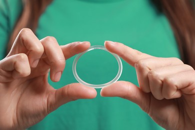 Photo of Woman holding diaphragm vaginal contraceptive ring, closeup