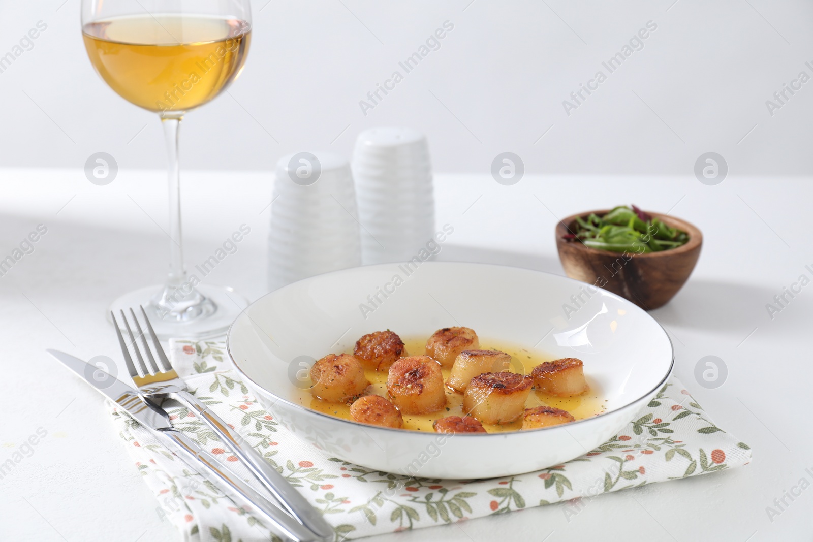 Photo of Delicious fried scallops served on white table