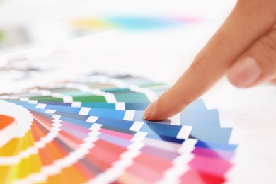 Photo of Woman with paint color palette samples, closeup
