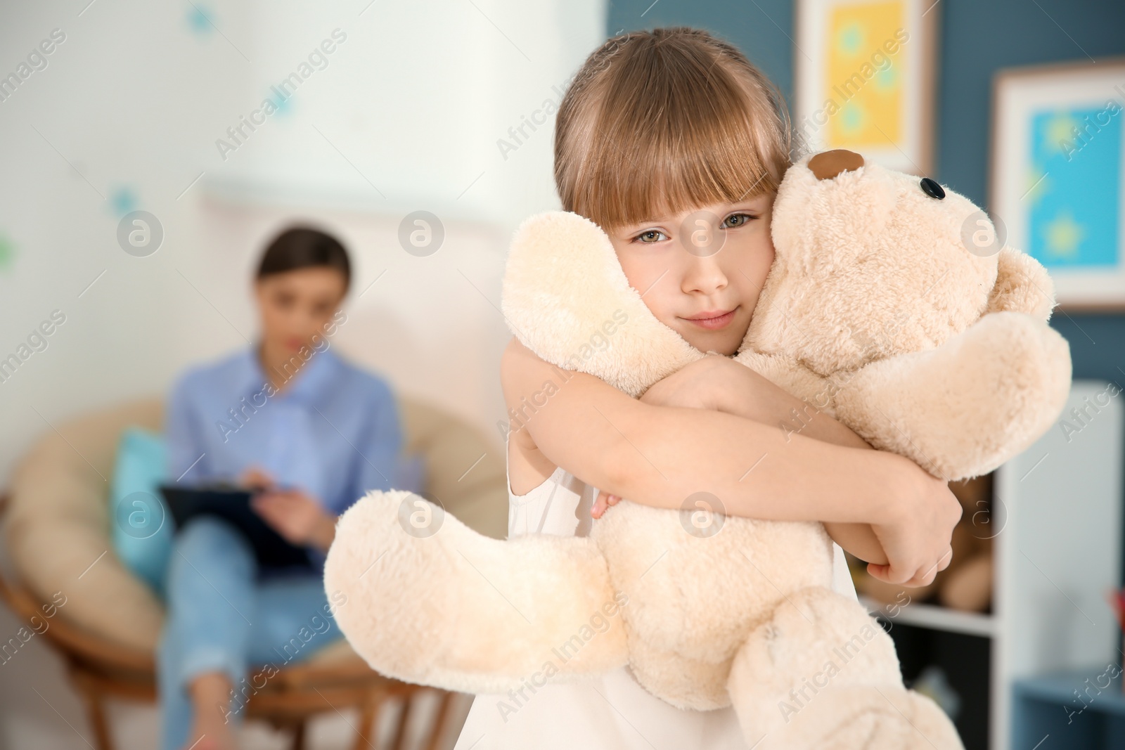 Photo of Sad little girl at child psychologist's office