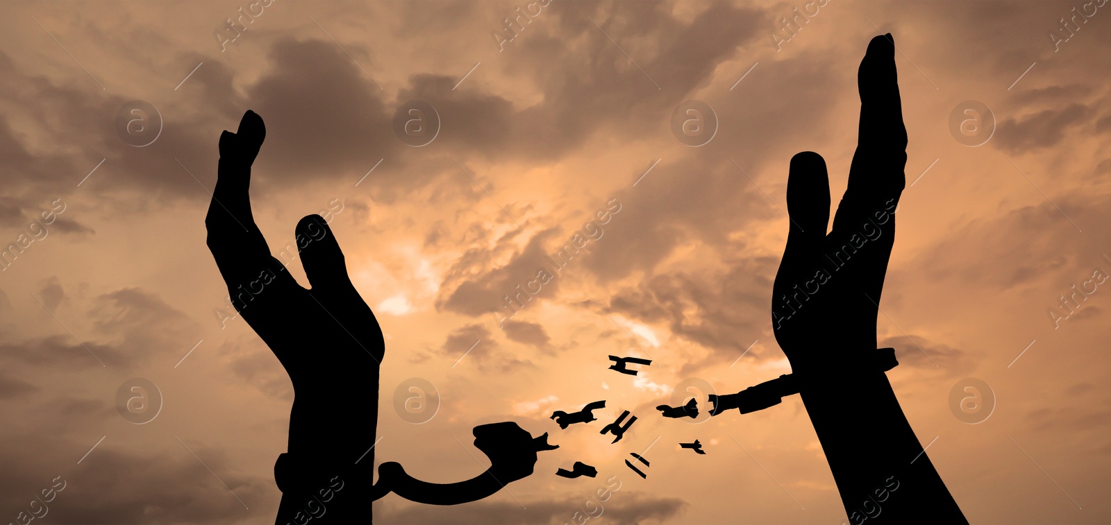 Image of Freedom. Woman with broken handcuffs against cloudy sky at sunset, closeup. Banner design