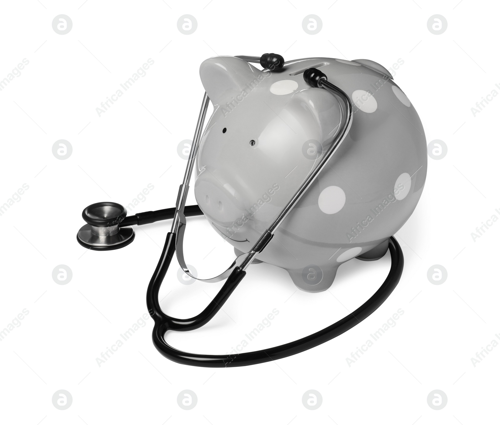 Photo of Piggy bank with stethoscope on white background. Medical insurance