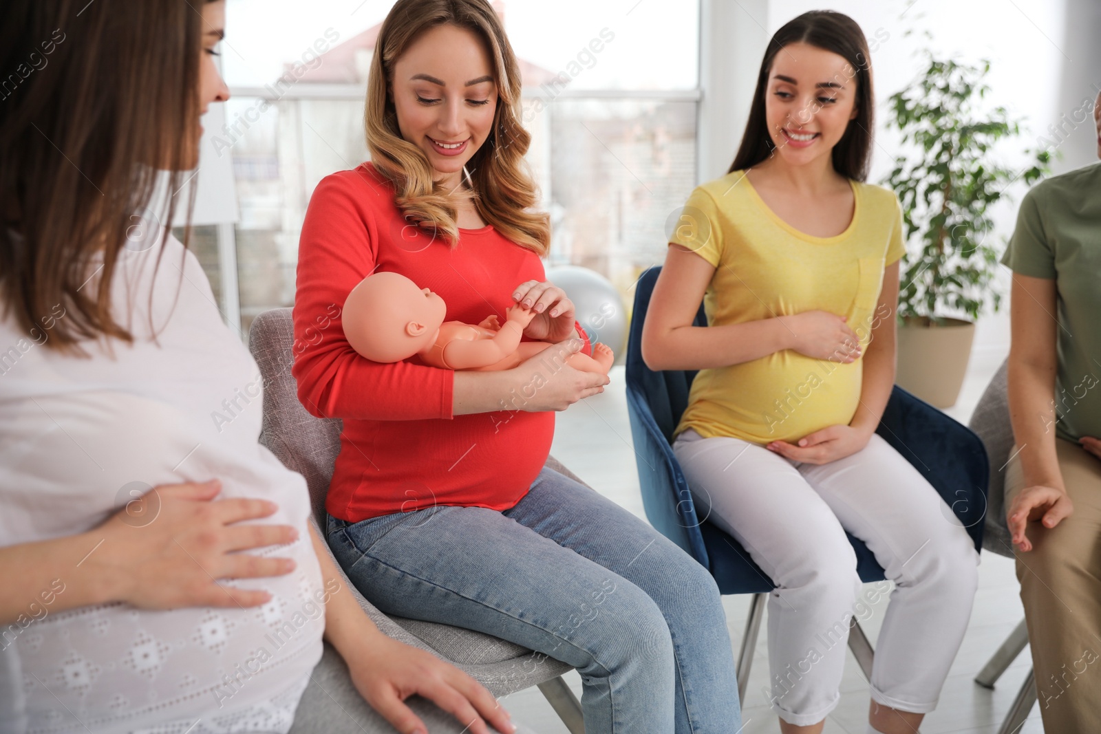 Photo of Group of pregnant women at courses for expectant mothers indoors