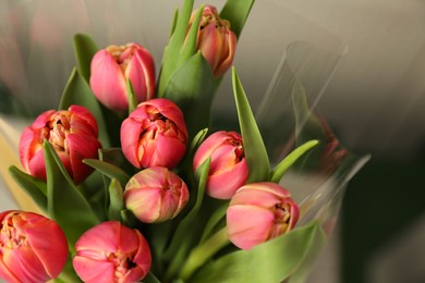 Photo of Beautiful bouquet of tulips on blurred background, top view