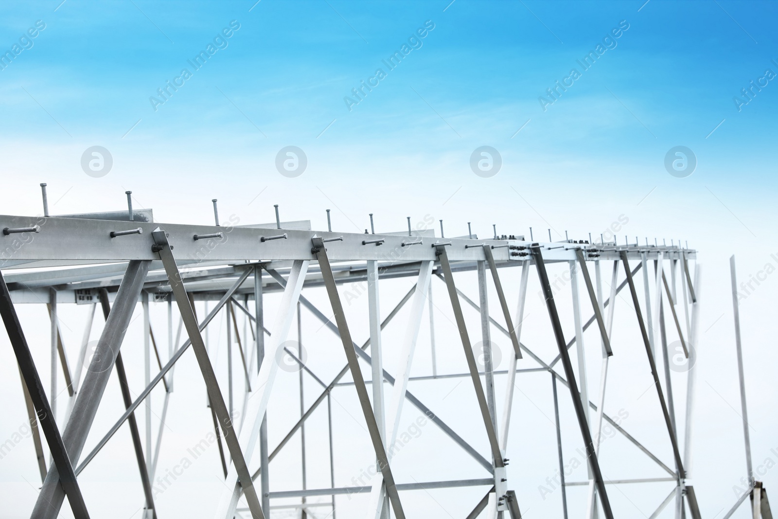 Photo of High voltage tower construction outdoors. Installation of electrical substation