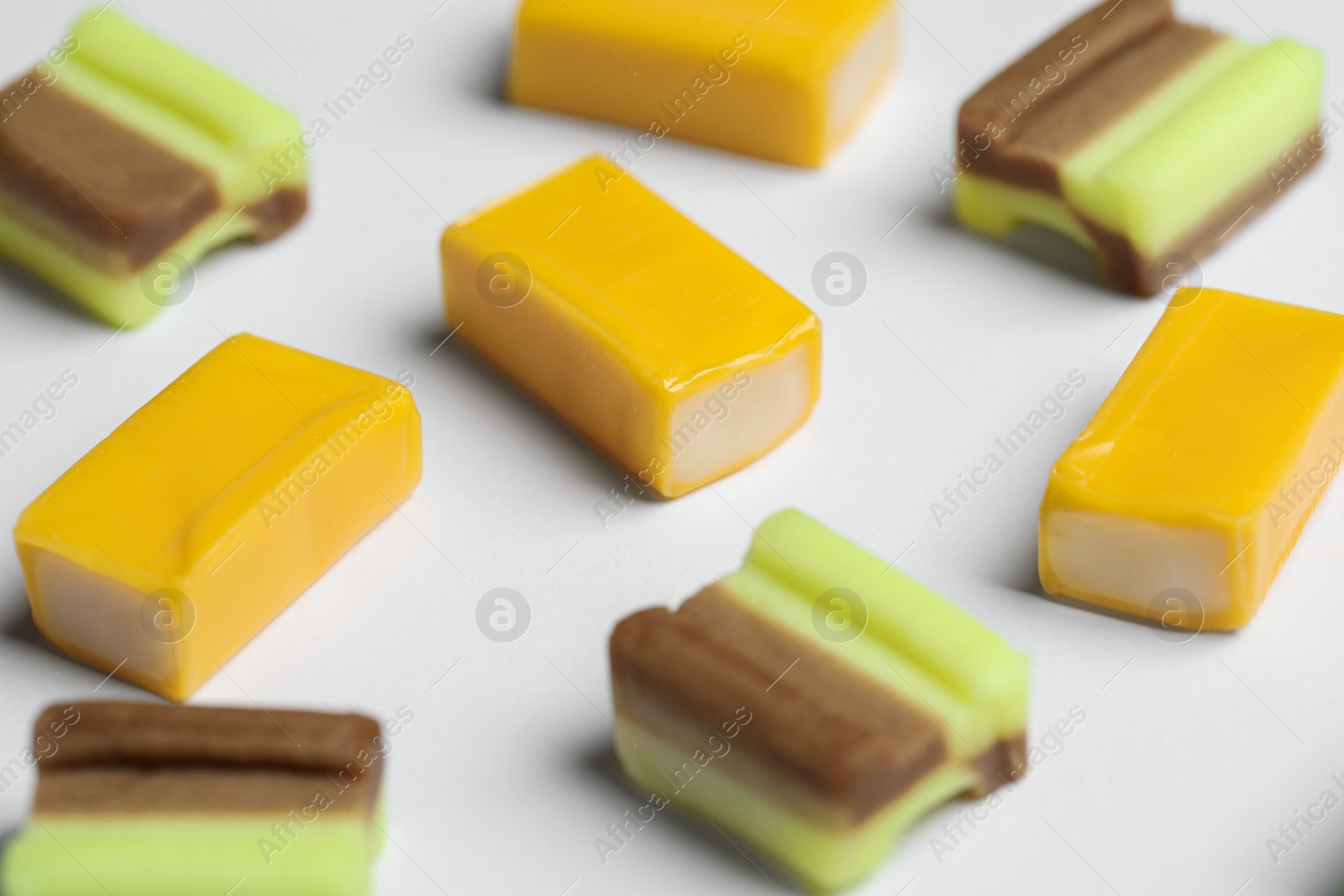 Photo of Different tasty colorful bubble gums on white background, closeup