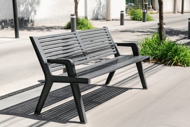 Photo of Metal bench in park on sunny day