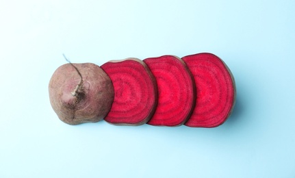 Photo of Cut fresh red beet on light blue background, flat lay