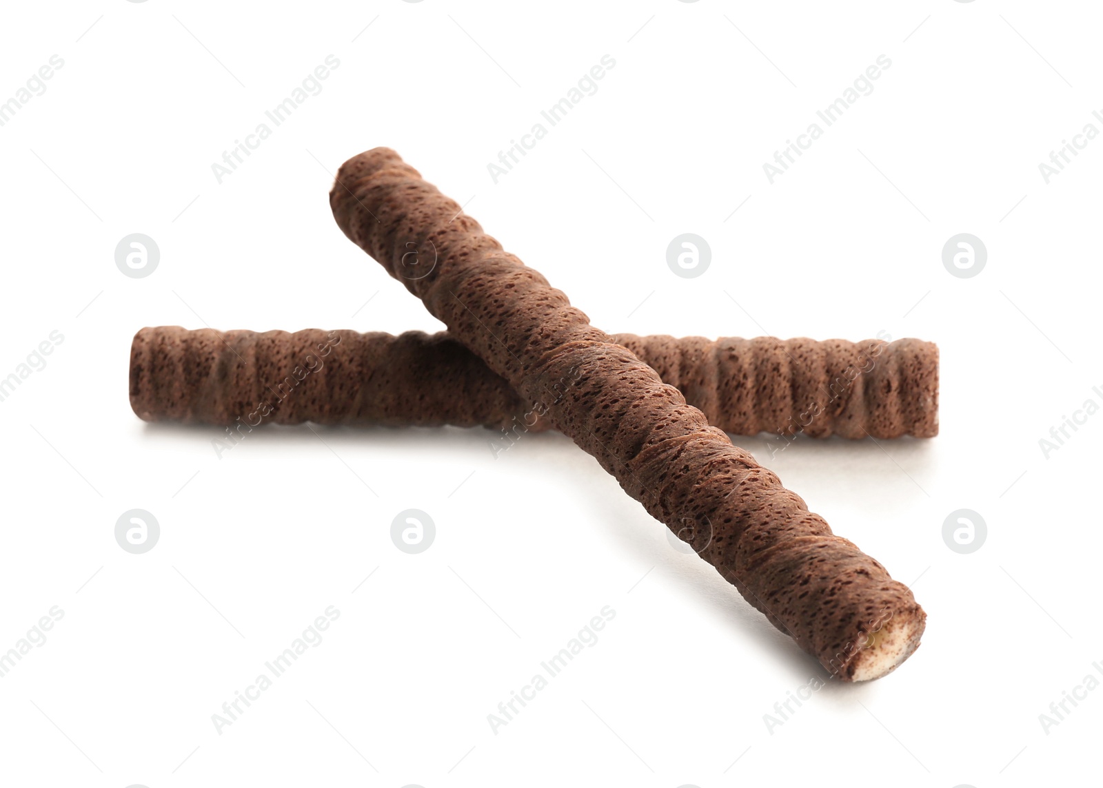 Photo of Delicious chocolate wafer rolls on white background. Sweet food