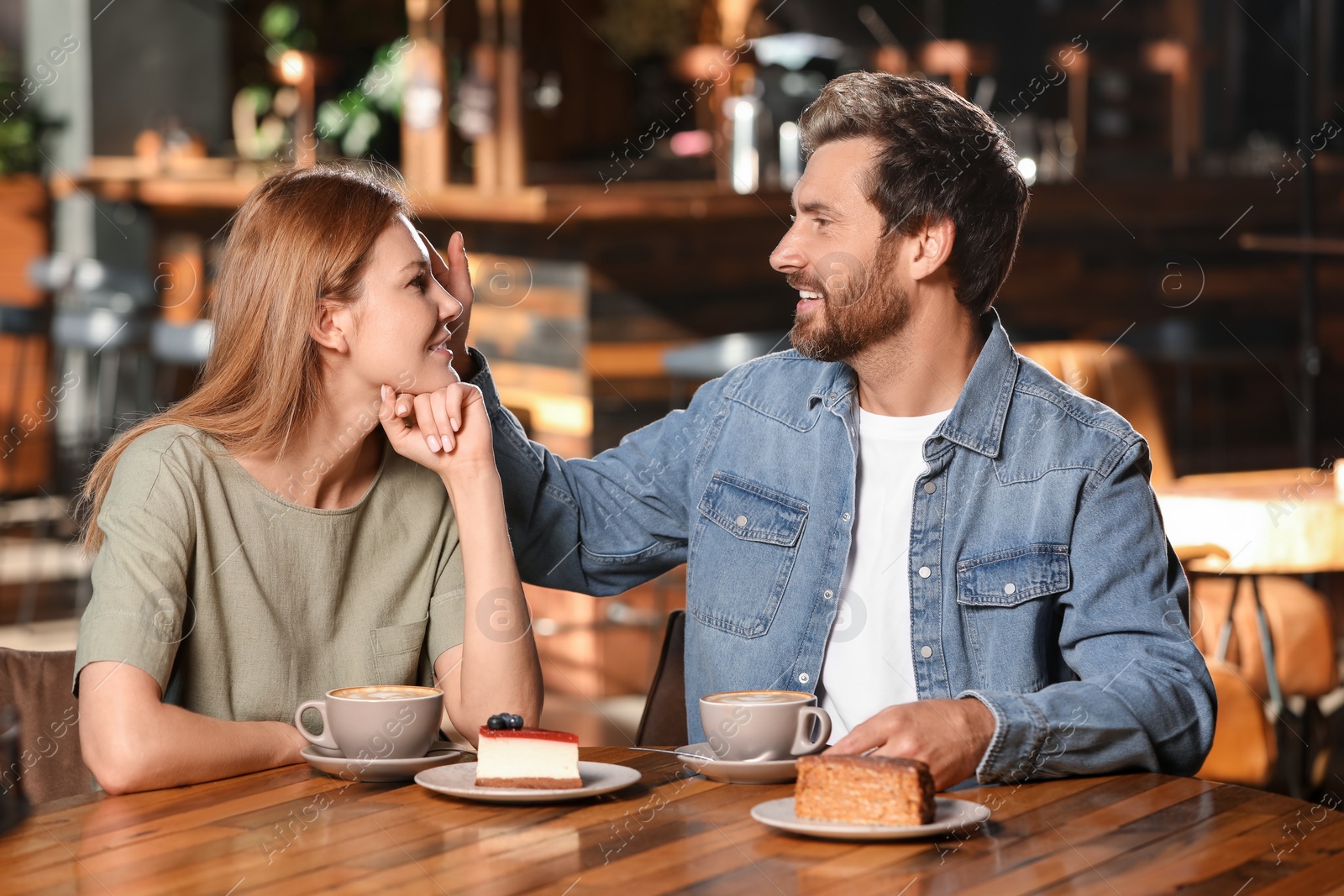 Photo of Romantic date. Happy couple spending time together in cafe