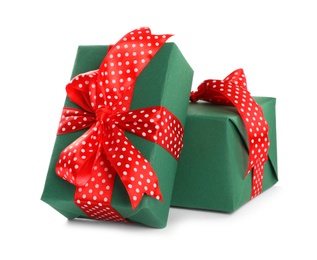 Photo of Christmas gift boxes decorated with red bows on white background